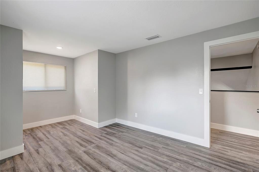 16133 Ravendale Drive Tampa, FL 33618 - Photo 37 of 46 a view of an empty room with wooden floor and a window