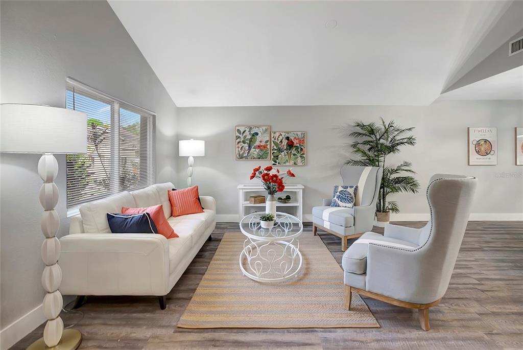 16133 Ravendale Drive Tampa, FL 33618 - Photo 4 of 46 a living room with furniture and a table