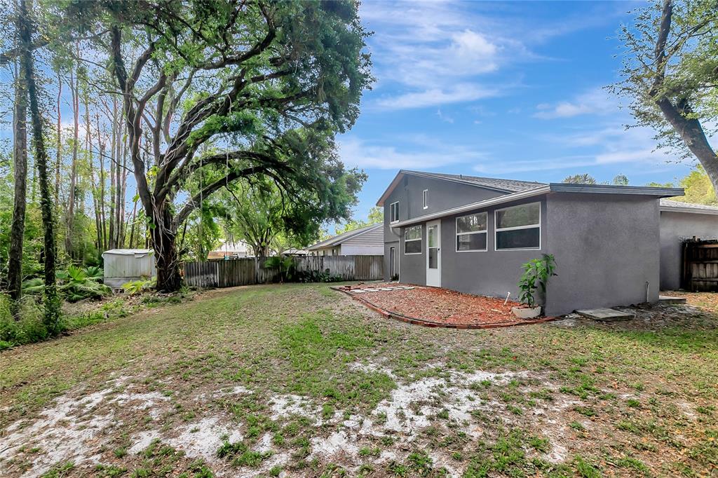 16133 Ravendale Drive Tampa, FL 33618 - Photo 42 of 46 a view of a house with backyard and tree