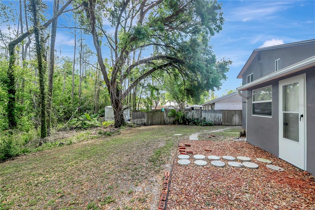 16133 Ravendale Drive Tampa, FL 33618 - Photo 43 of 46 a view of a yard with plants and trees