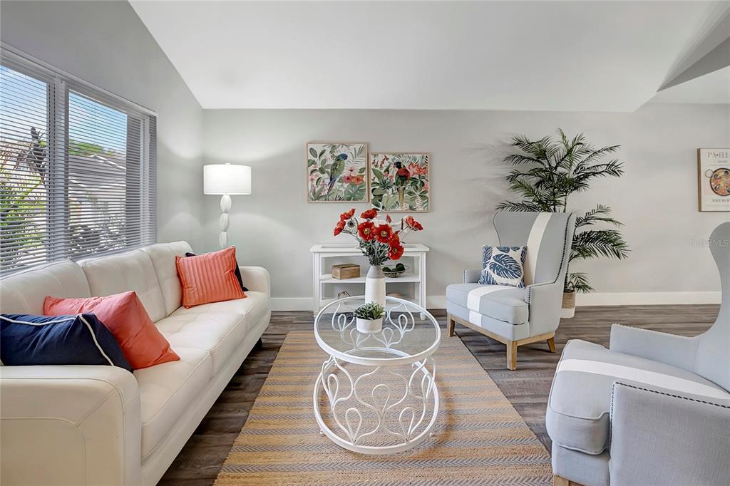 16133 Ravendale Drive Tampa, FL 33618 - Photo 7 of 46 a living room with furniture a table and decor