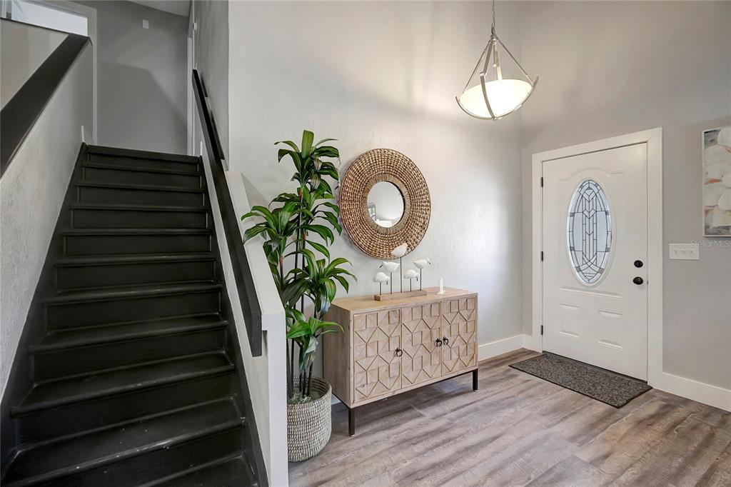 16133 Ravendale Drive Tampa, FL 33618 - Photo 8 of 46 a view of entryway and hall with wooden floor
