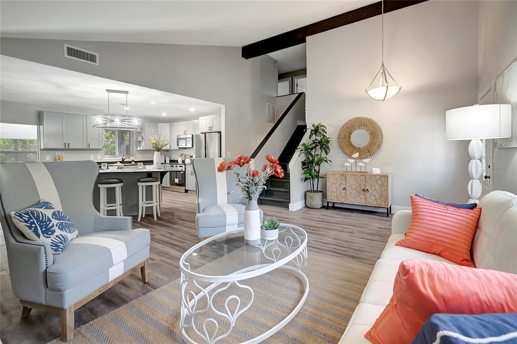 16133 Ravendale Drive Tampa, FL 33618 - Photo 10 of 46 a living room with furniture a clock and wooden floor