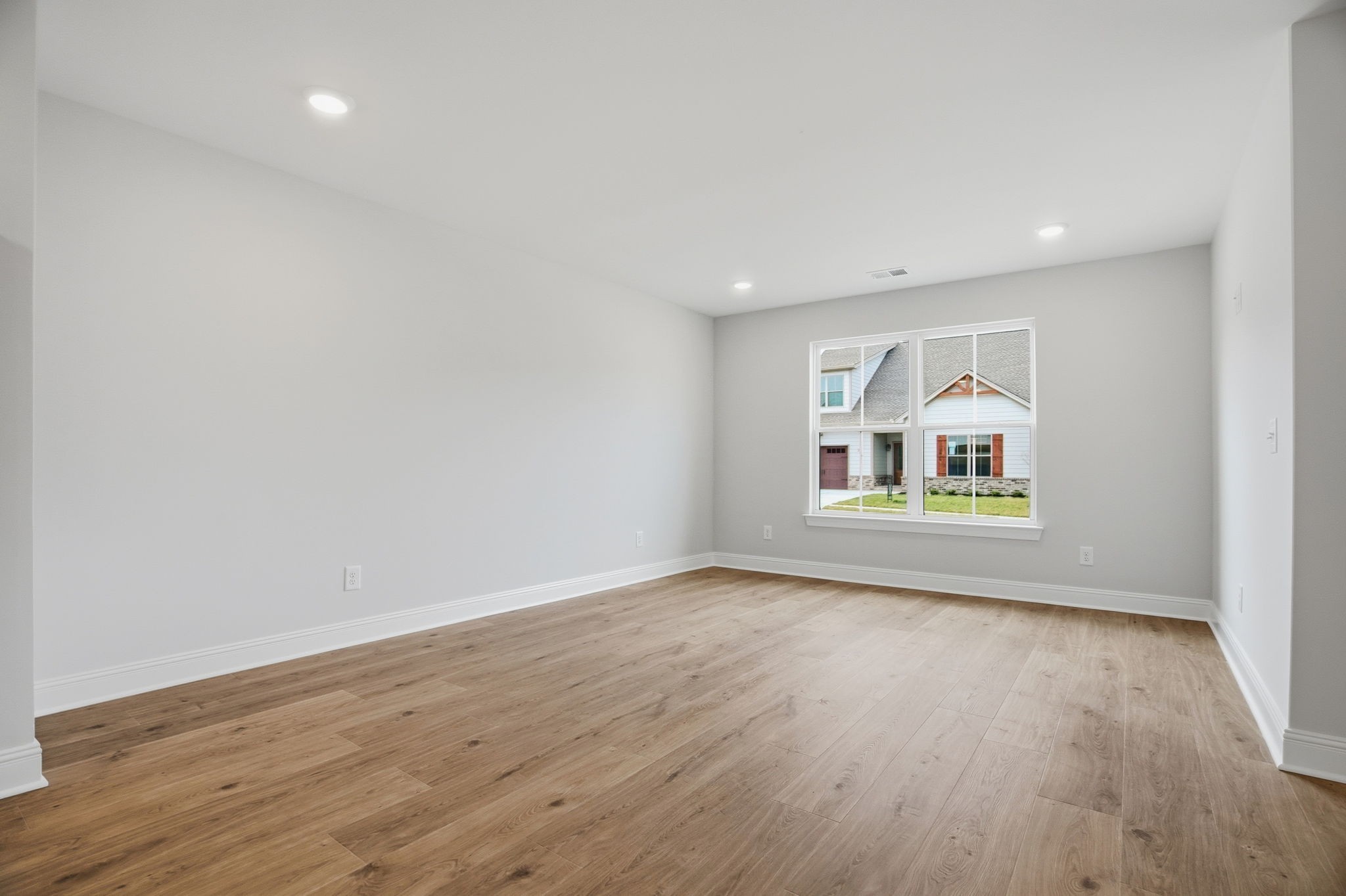 2139 Rylee Way, Unit 6 Greenbrier, TN 37073 - Photo 11 of 32 an empty room with wooden floor and windows