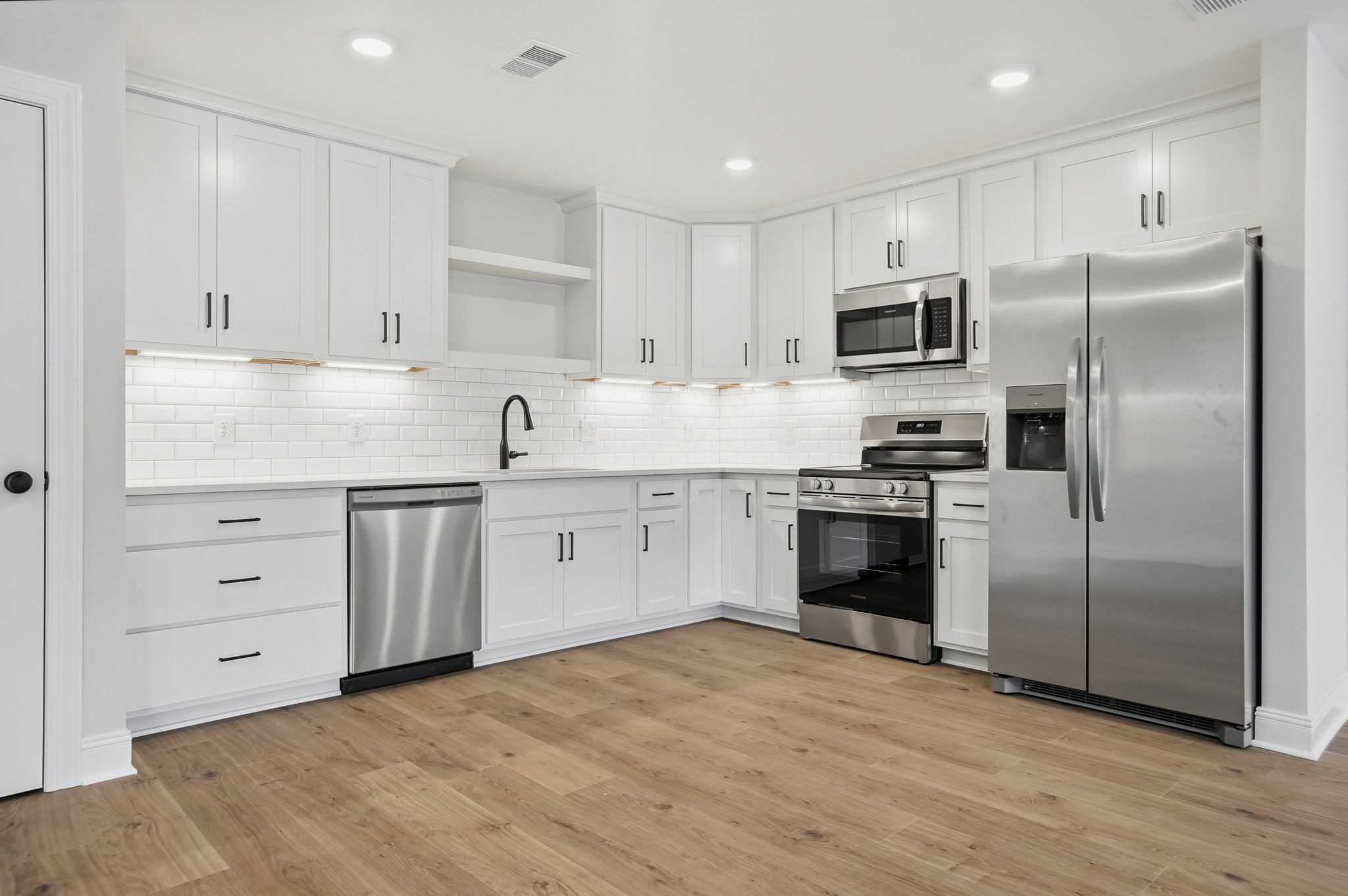 2139 Rylee Way, Unit 6 Greenbrier, TN 37073 - Photo 13 of 32 a kitchen with granite countertop a refrigerator stove a sink and white cabinets