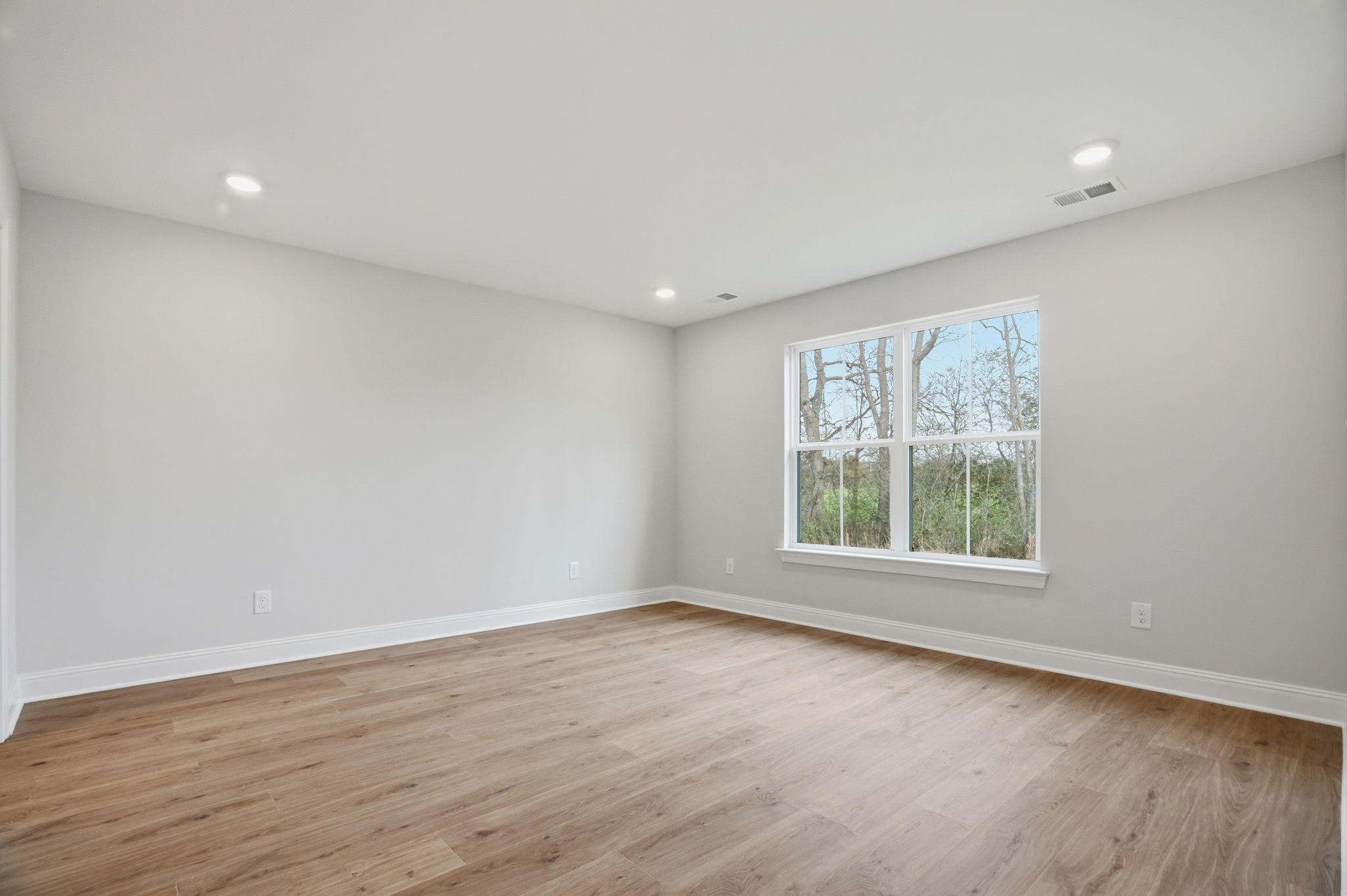 2139 Rylee Way, Unit 6 Greenbrier, TN 37073 - Photo 21 of 32 an empty room with wooden floor and windows