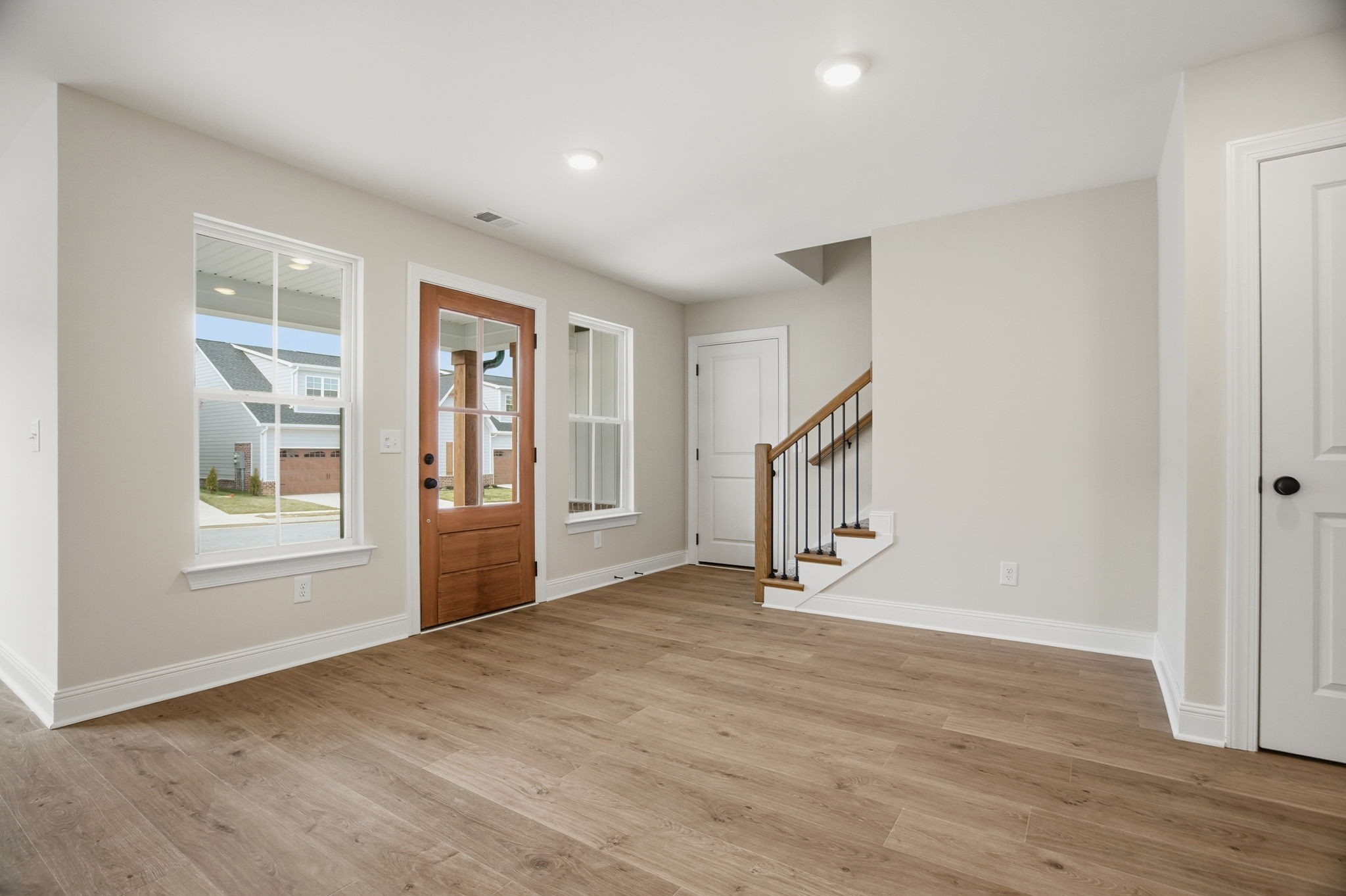 2139 Rylee Way, Unit 6 Greenbrier, TN 37073 - Photo 8 of 32 a view of an empty room with wooden floor and a window