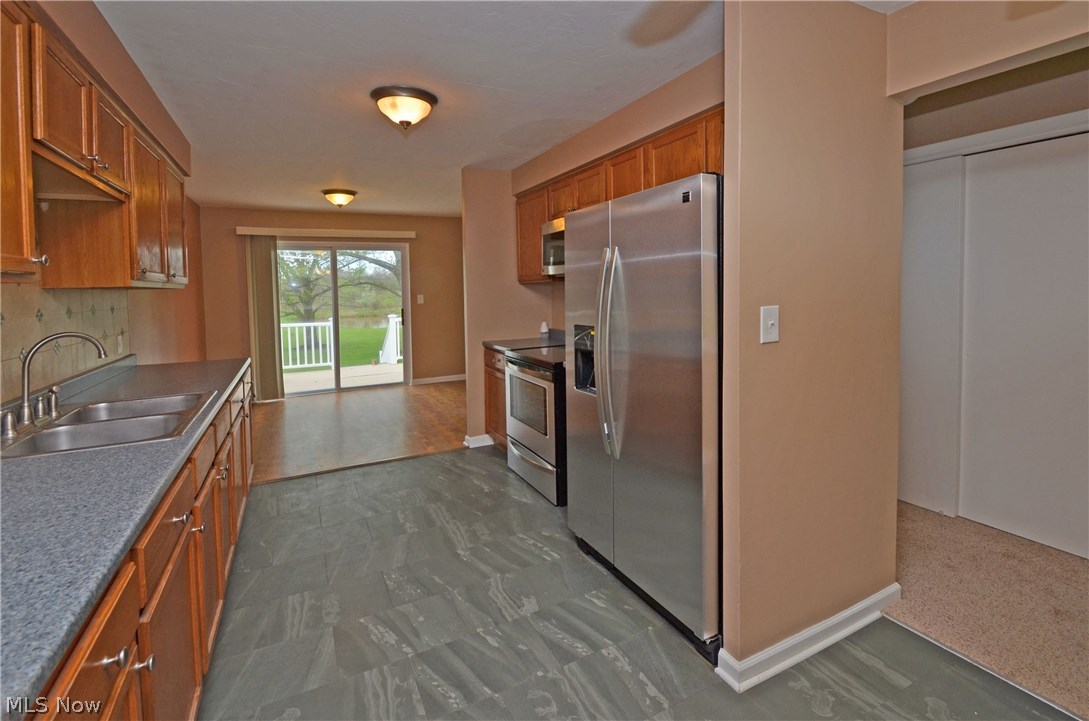 1320 Substation Road Brunswick, OH 44212 - Photo 12 of 24 Slider leads to back deck and scenic yard overlooking pond
