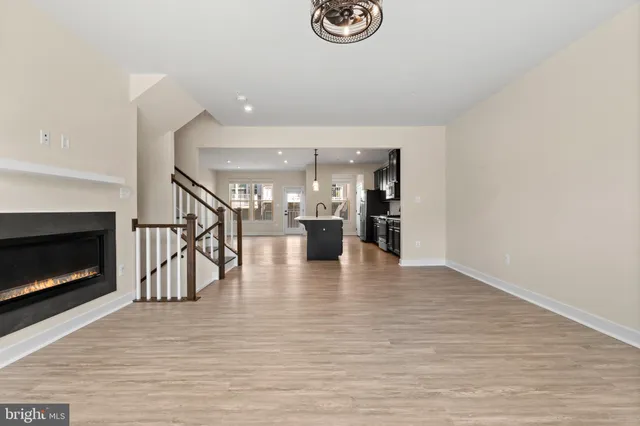 a view of a kitchen and an empty room