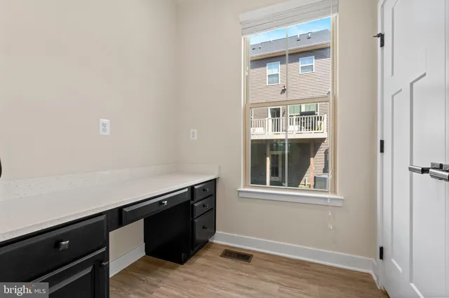 a room with a wooden floor and a window