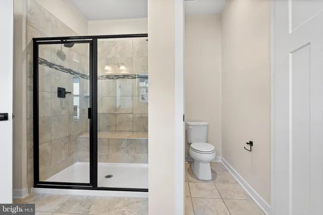 a bathroom with a toilet and a shower