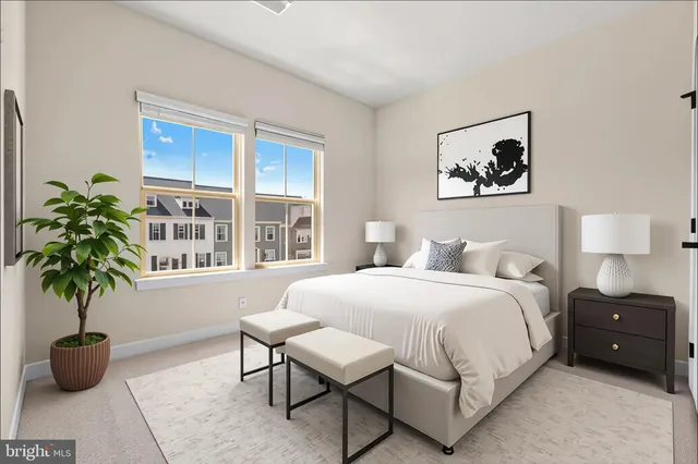 a bedroom with a bed and a potted plant