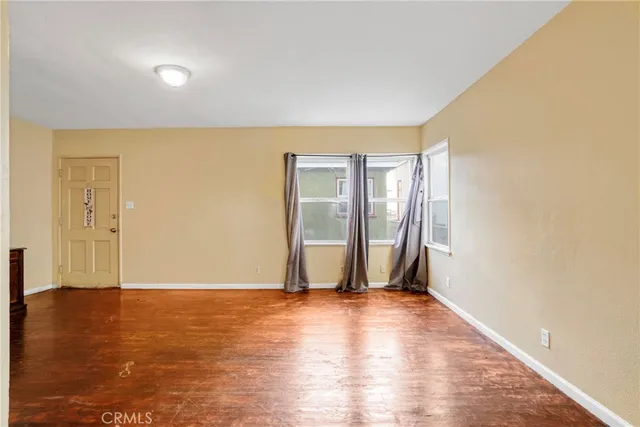 a kitchen with granite countertop a sink stove and refrigerator