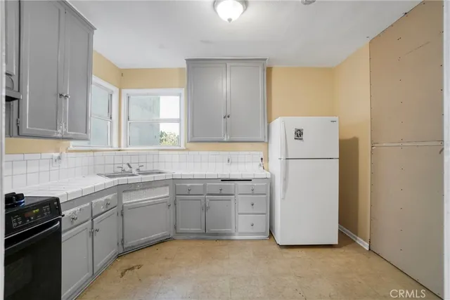 a kitchen with a sink stove and cabinets
