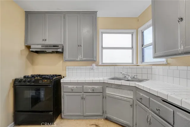 a view of a room with wooden floor and a window