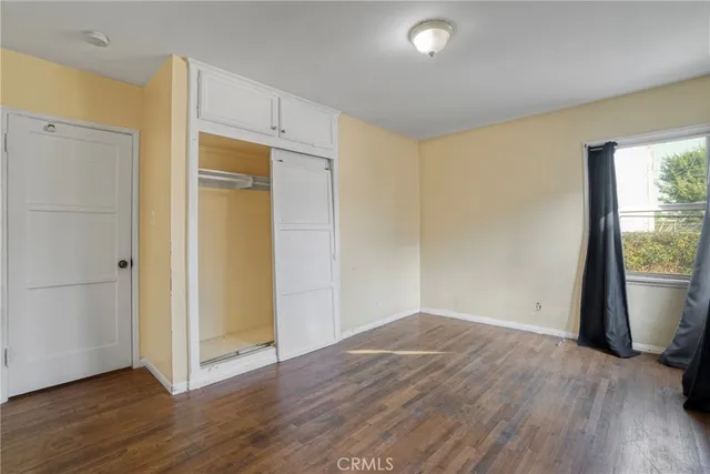 a view of a kitchen with wooden cabinet