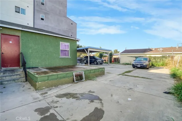 a view of a brick house with a small yard