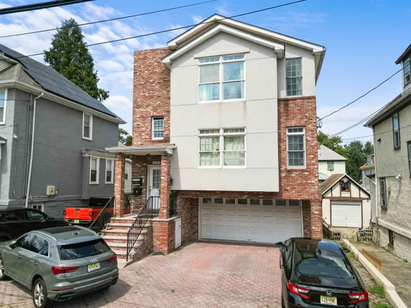 a car parked in front of a white house