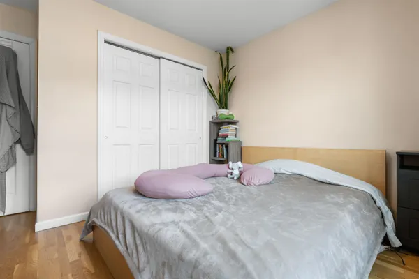 a bedroom with a bed and a potted plant