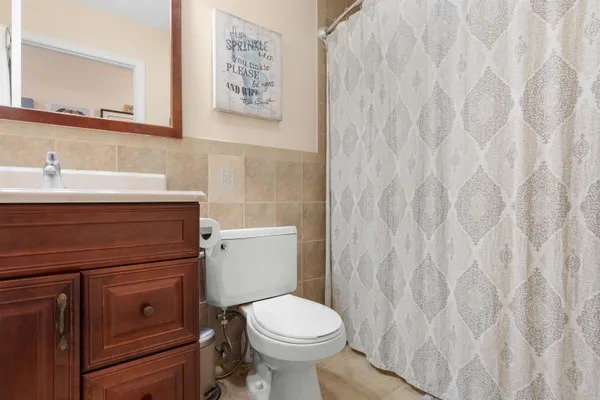 a bathroom with a toilet sink and vanity
