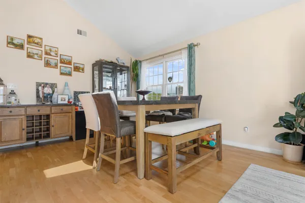 a dining room with furniture and wooden floor