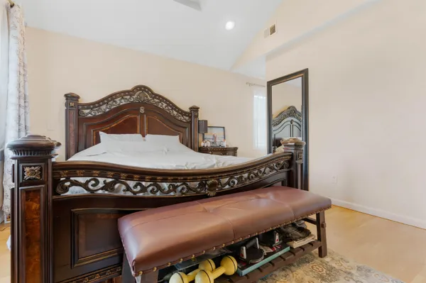 a bed sitting in a bedroom next to a window