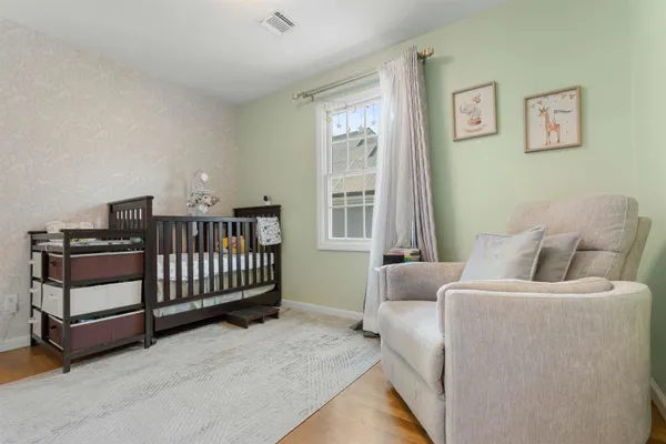 a bedroom with furniture and a window