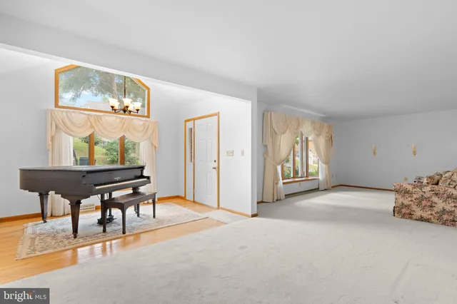 a kitchen with stainless steel appliances granite countertop a stove a sink dishwasher and a refrigerator with wooden cabinets