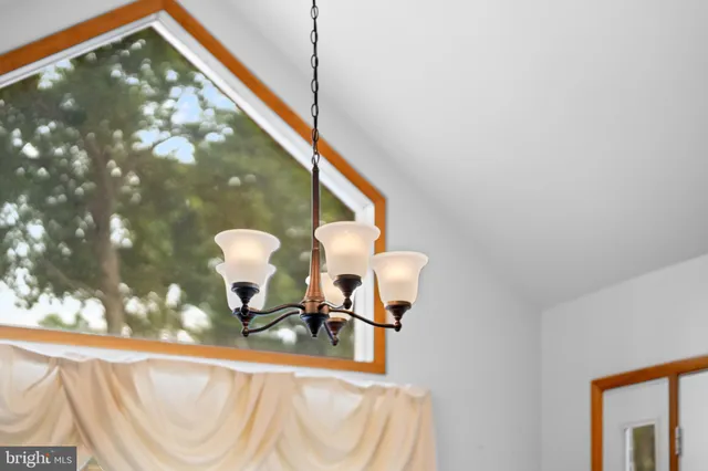 a view of a livingroom with wooden furniture and a window