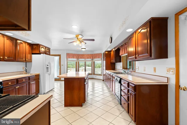 a view of kitchen with furniture and refrigerator