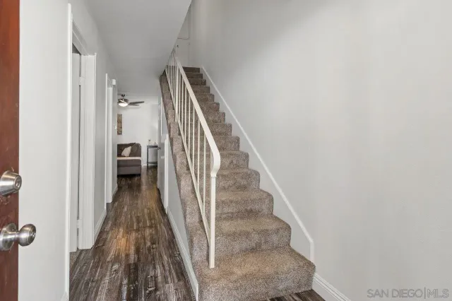 a view of a room with furniture and windows