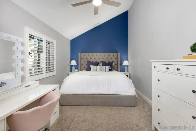 a large bed sitting in a bedroom next to a window