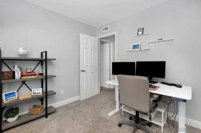 a view of workspace with furniture and window