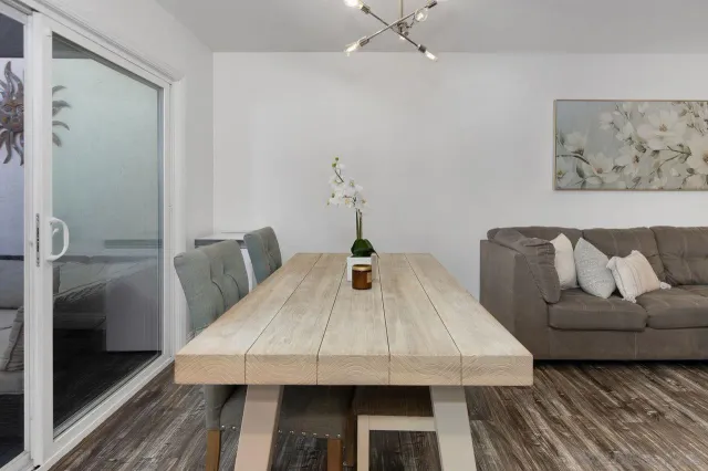 a view of a dining room with furniture and wooden floor