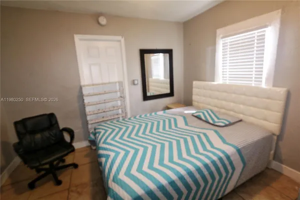 a bedroom with a bed and a window