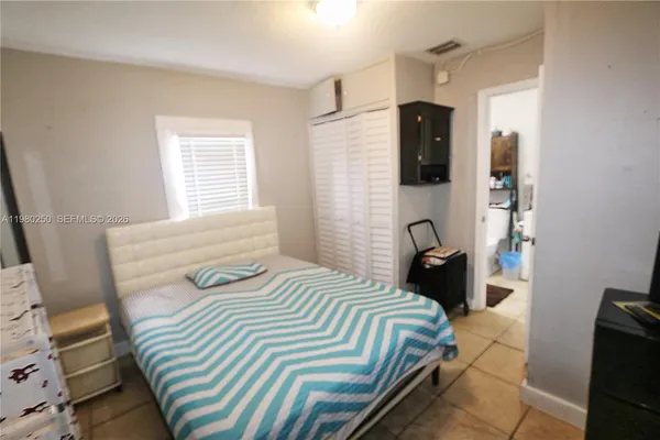 a bedroom with a bed and a flat screen tv