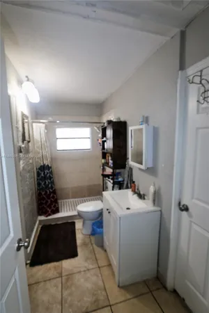 a room with a toilet a sink and a mirror
