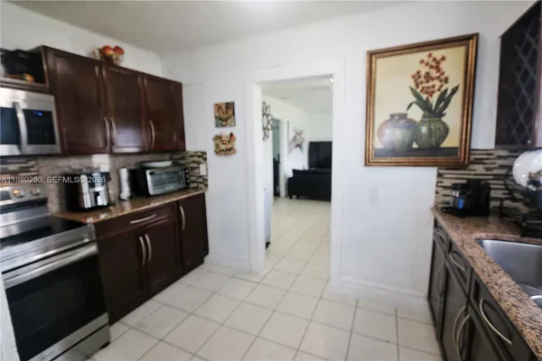 a kitchen with a sink and a refrigerator
