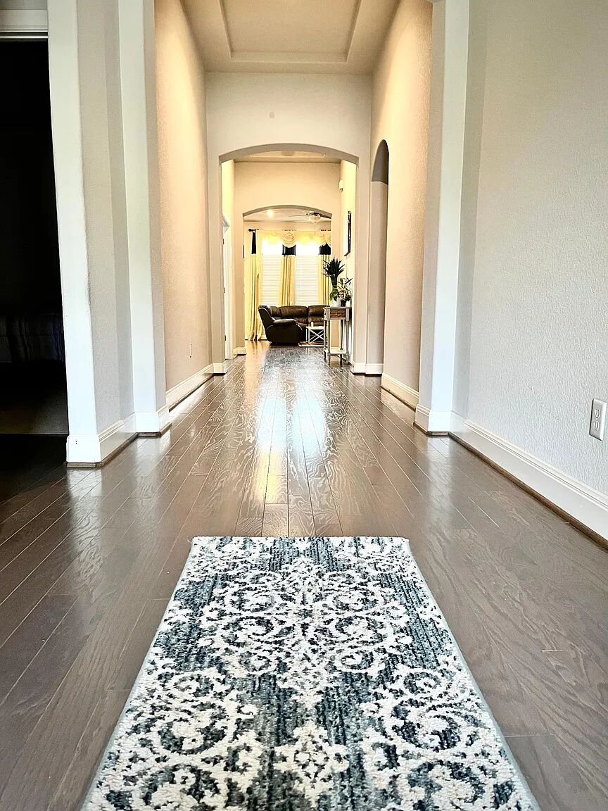 4221 Borho Ranch Street Leander, TX 78641 - Photo 4 of 16 The property features a hallway with hardwood flooring and arched doorways