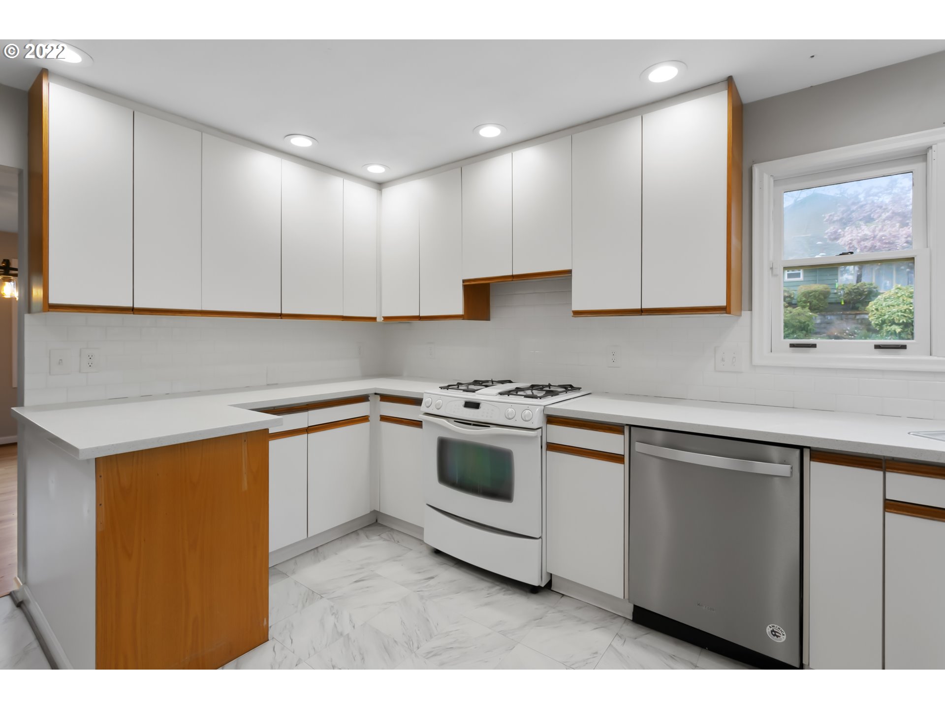 225 Southwest Carson Street Portland, OR 97219 - Photo 14 of 32 a kitchen with stainless steel appliances granite countertop a stove a sink and a microwave