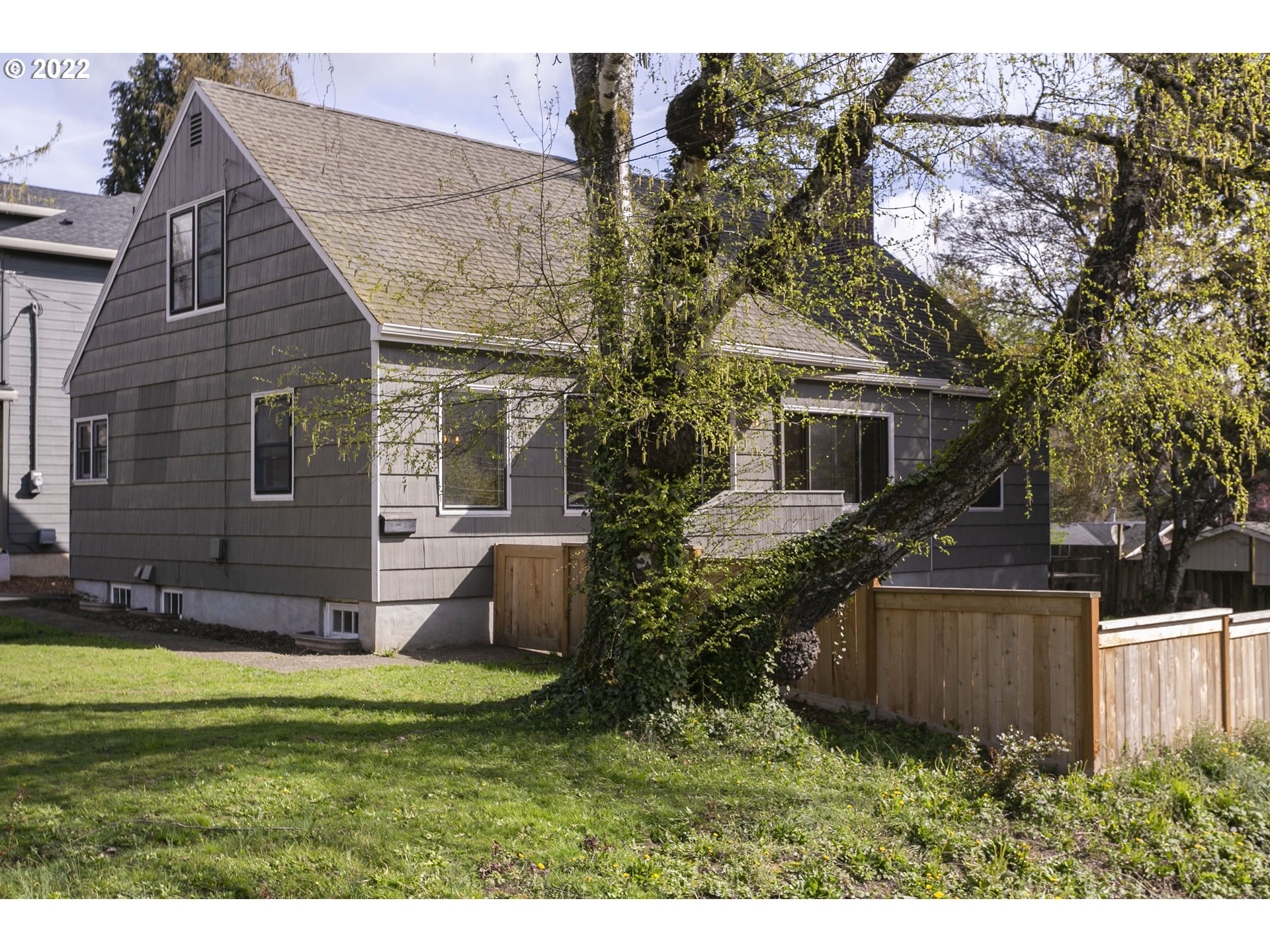 225 Southwest Carson Street Portland, OR 97219 - Photo 2 of 32 a view of a house with backyard and sitting area