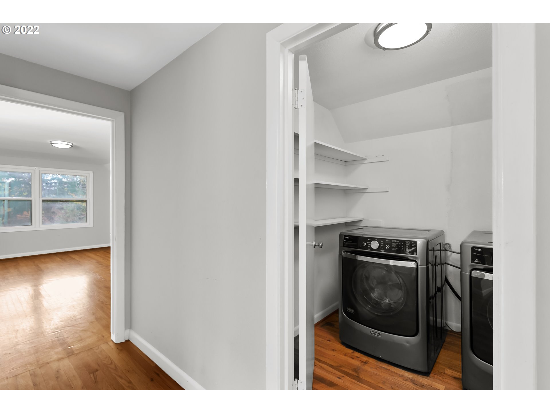 225 Southwest Carson Street Portland, OR 97219 - Photo 22 of 32 a view of a hallway with wooden floor and a fireplace
