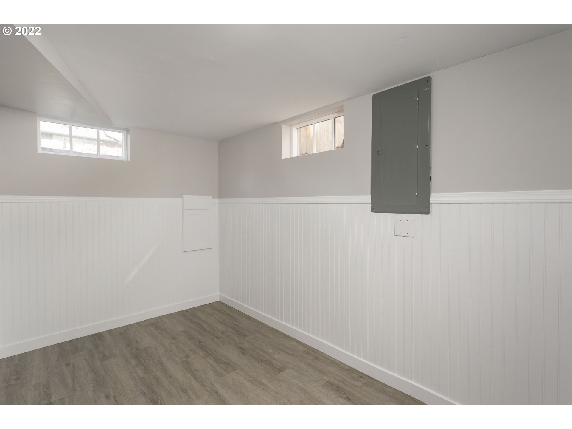 225 Southwest Carson Street Portland, OR 97219 - Photo 26 of 32 a view of an empty room with wooden floor and windows