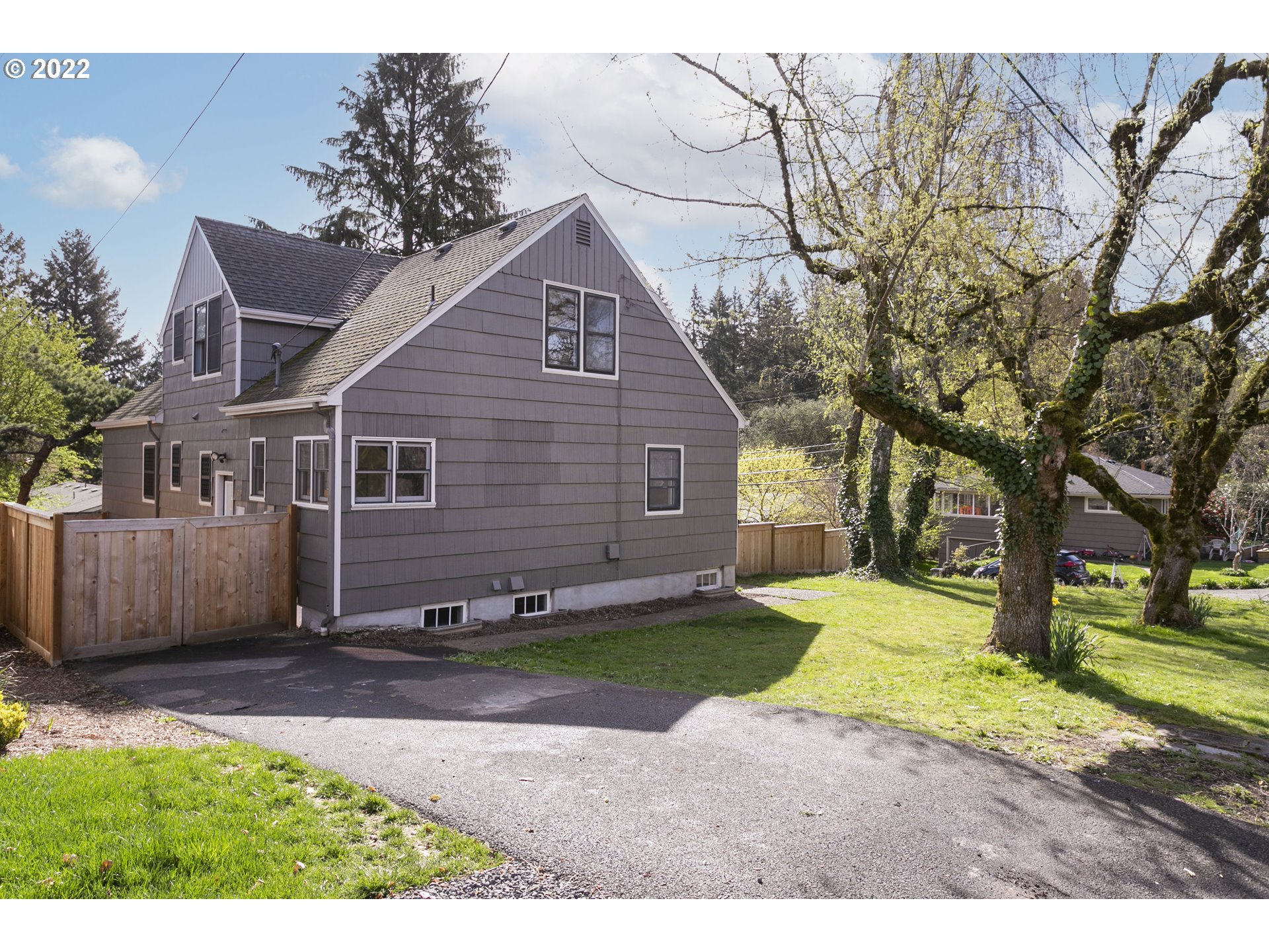 225 Southwest Carson Street Portland, OR 97219 - Photo 32 of 32 a view of a yard in front of a house with a large tree