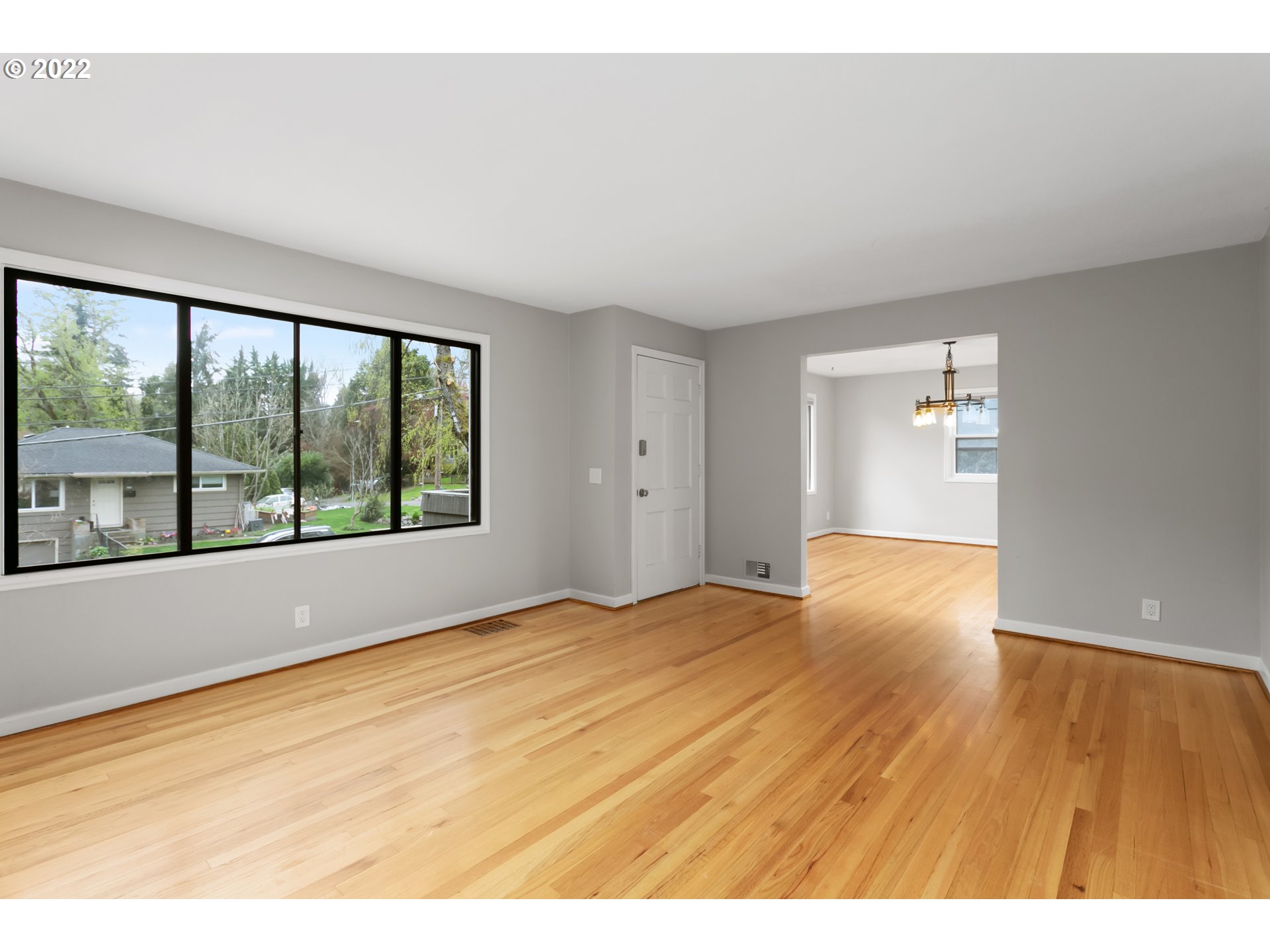 225 Southwest Carson Street Portland, OR 97219 - Photo 7 of 32 a view of an empty room with wooden floor and a window