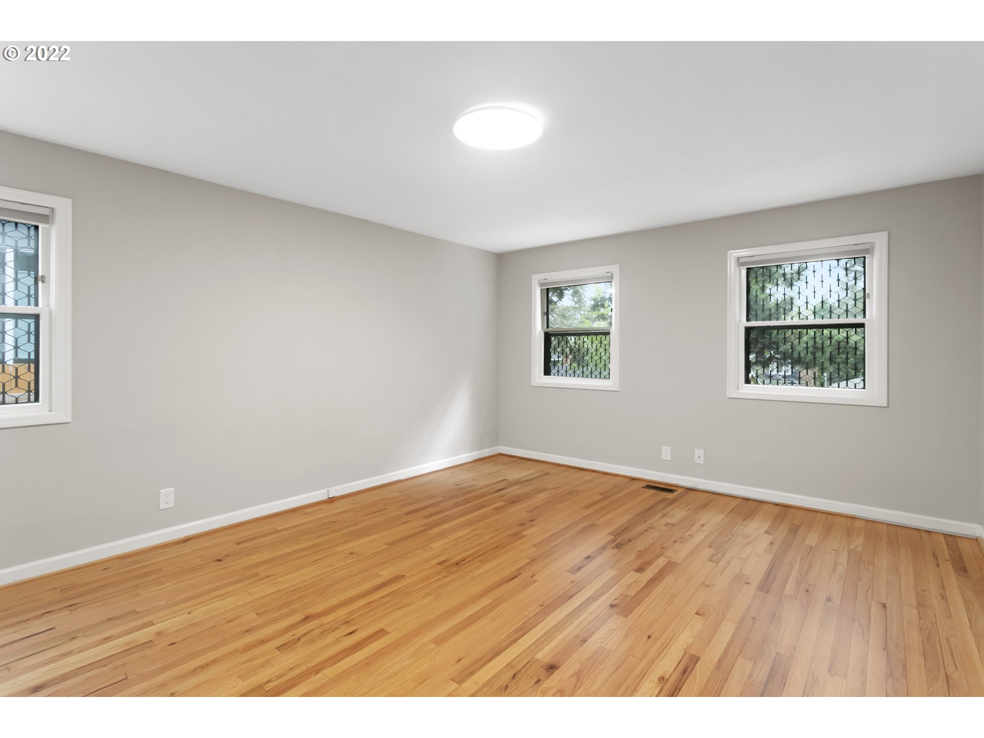 225 Southwest Carson Street Portland, OR 97219 - Photo 9 of 32 a view of an empty room with wooden floor and a window