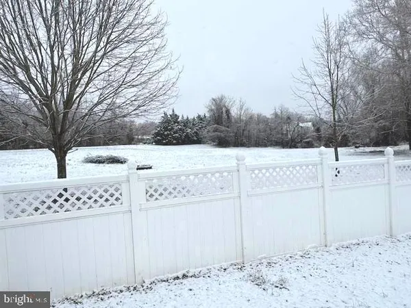 a view of a white house with a yard