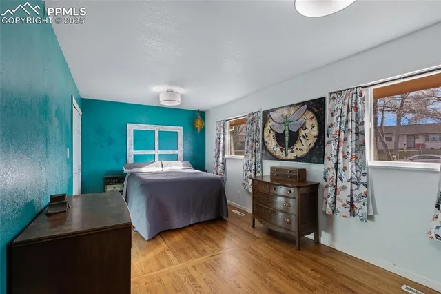 a view of a house with backyard and wooden fence