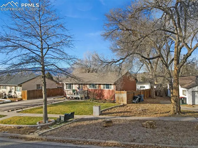 a front view of a house with swimming pool table and chairs