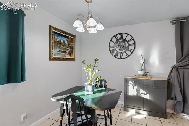 a kitchen with stainless steel appliances kitchen island granite countertop a refrigerator a stove top oven a sink dishwasher and couches with wooden floor